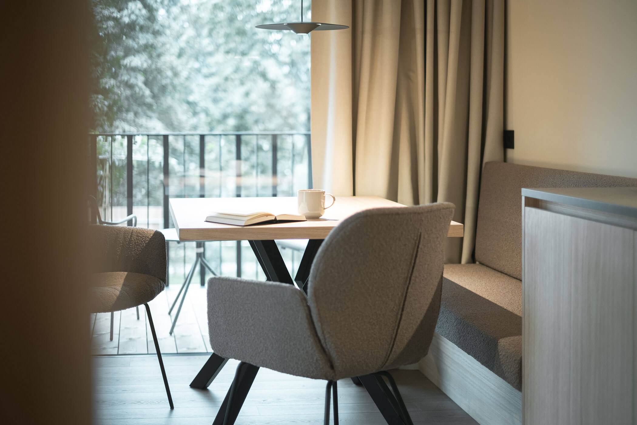 Table with book and cup, two chairs beside - Gisse Zwölf